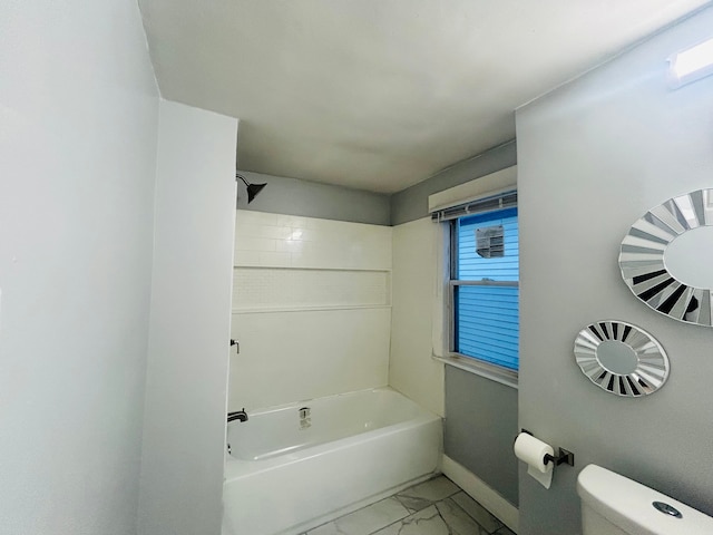 bathroom featuring toilet and bathtub / shower combination