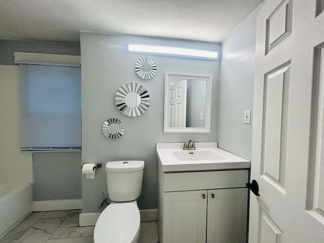 bathroom featuring a washtub, toilet, and vanity