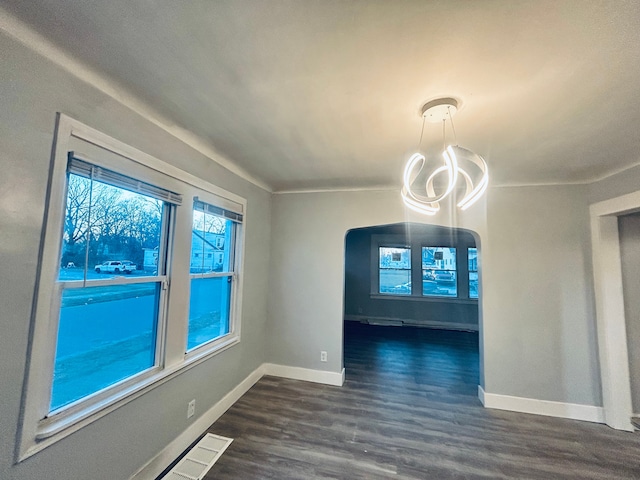 unfurnished dining area featuring dark wood-type flooring