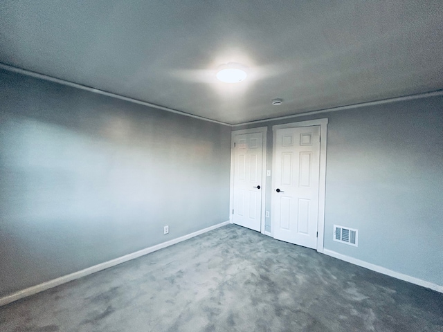 unfurnished bedroom featuring dark colored carpet