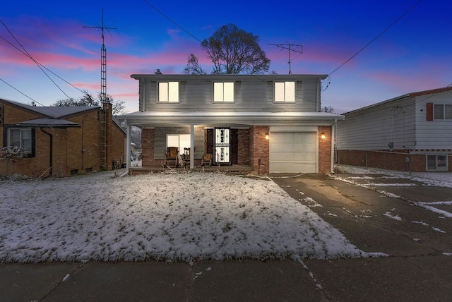 view of front of home featuring covered porch and a garage