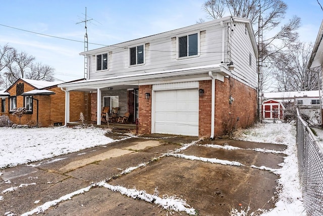 view of property with covered porch and a garage