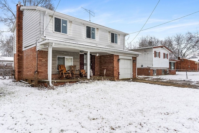 front of property featuring a porch and a garage