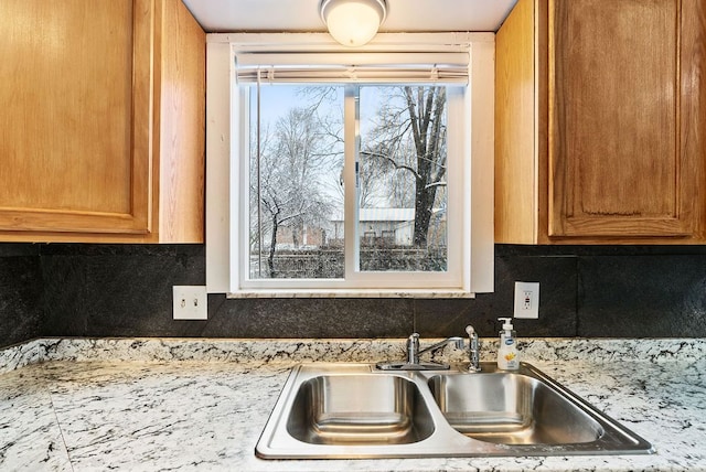 kitchen featuring tasteful backsplash and sink