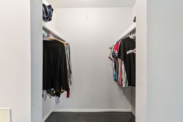 walk in closet featuring dark wood-type flooring