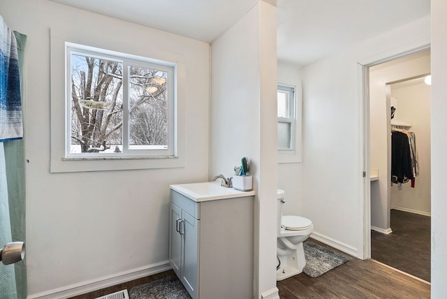 bathroom featuring hardwood / wood-style flooring, vanity, and toilet