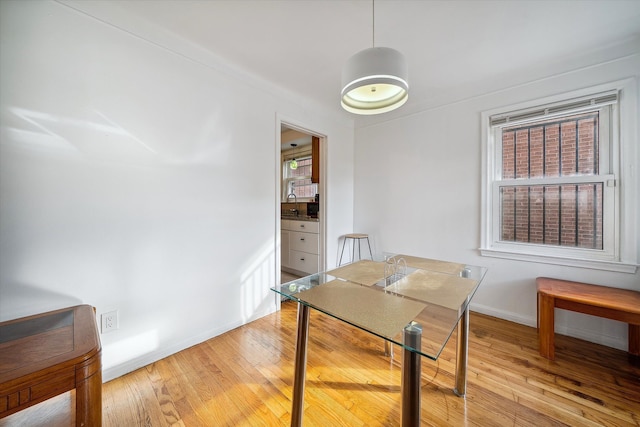 dining space featuring light hardwood / wood-style floors and sink