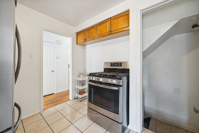 kitchen with light tile patterned floors and stainless steel appliances