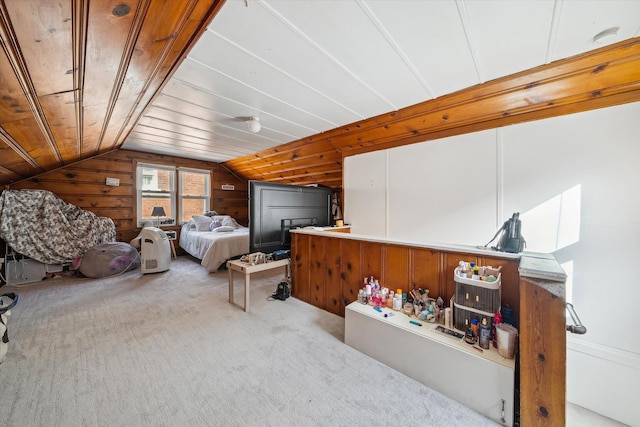 bedroom with wood walls, light colored carpet, and lofted ceiling