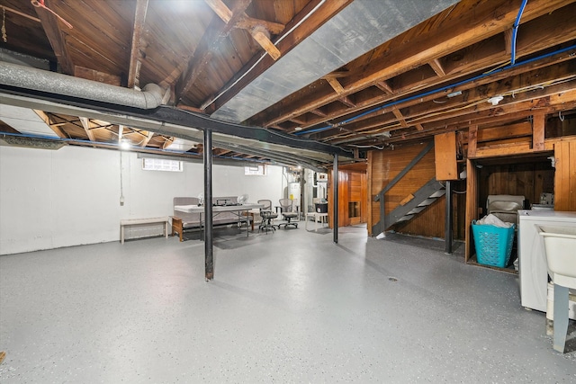 basement featuring washer and clothes dryer and gas water heater