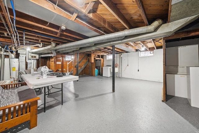 basement featuring gas water heater and washer / clothes dryer