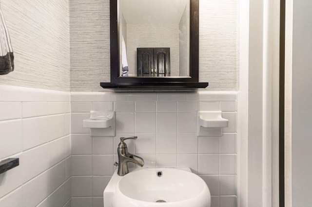 bathroom featuring tile walls and sink