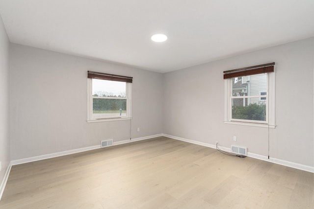 spare room with light hardwood / wood-style flooring