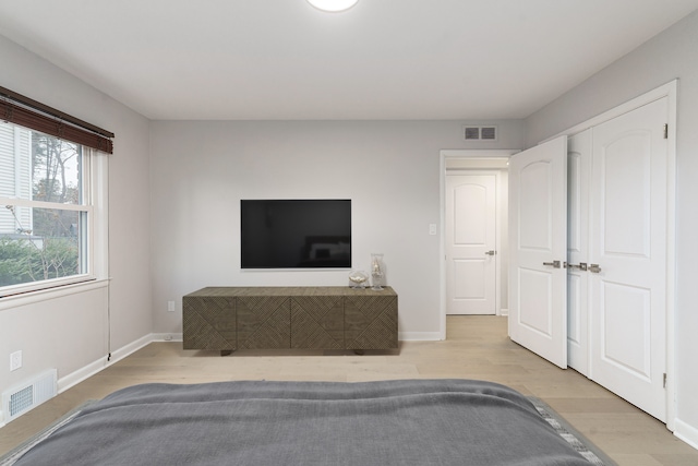 bedroom featuring a closet and light hardwood / wood-style flooring