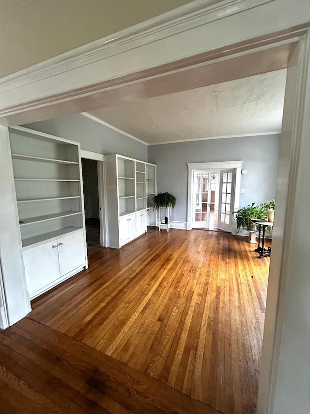 interior space featuring ornamental molding, hardwood / wood-style floors, and french doors