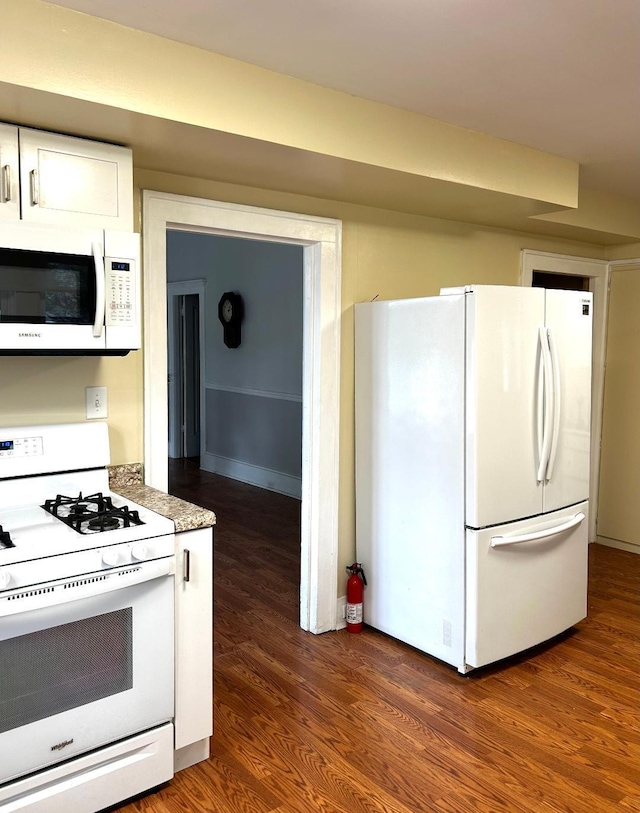 kitchen with white cabinetry, white appliances, light countertops, and dark wood-style floors