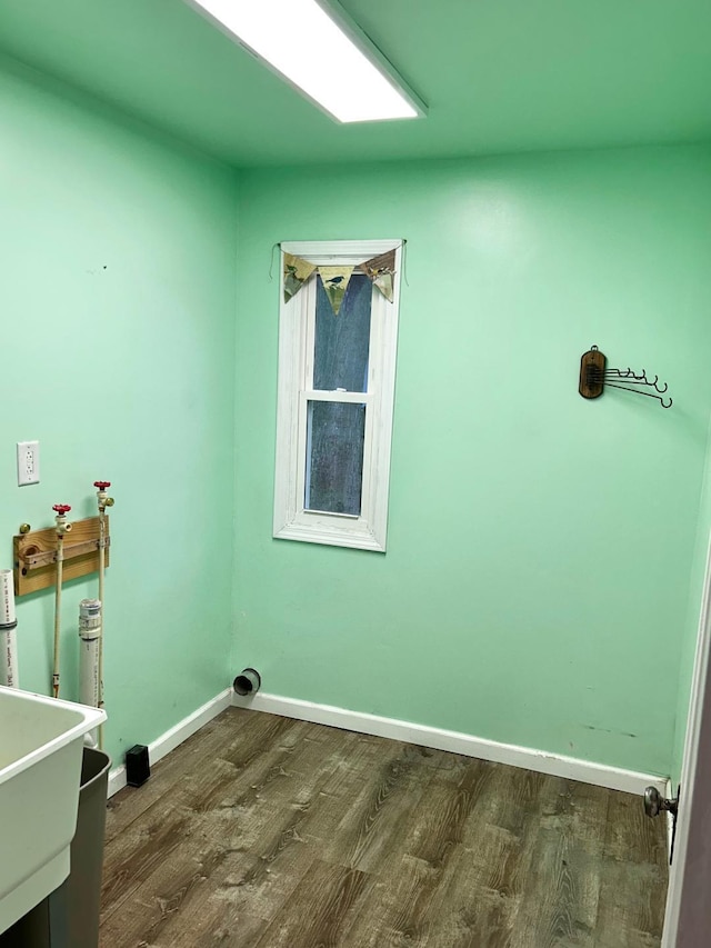 washroom with baseboards, laundry area, and dark wood-style floors
