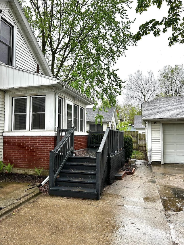 exterior space with concrete driveway and fence