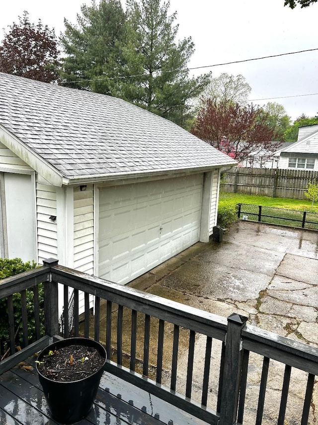 detached garage featuring fence