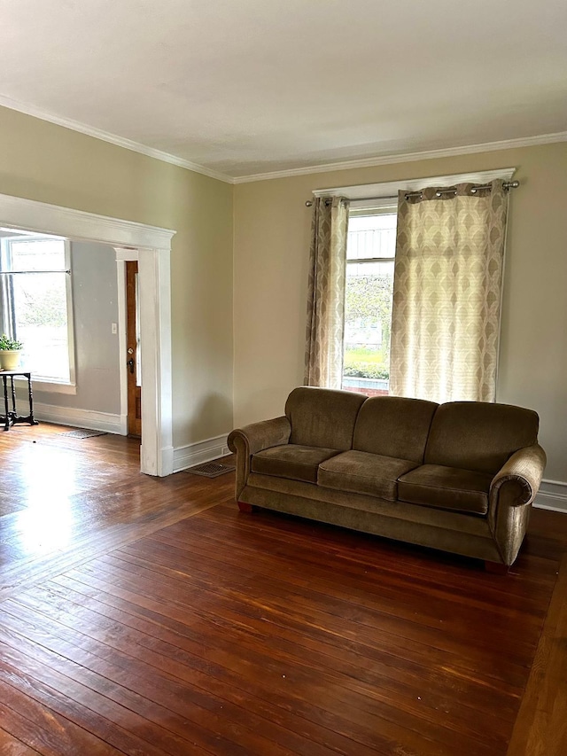 living room featuring ornamental molding, a wealth of natural light, baseboards, and wood-type flooring
