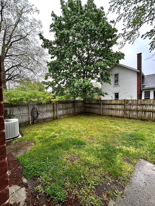 view of yard with a fenced backyard and cooling unit