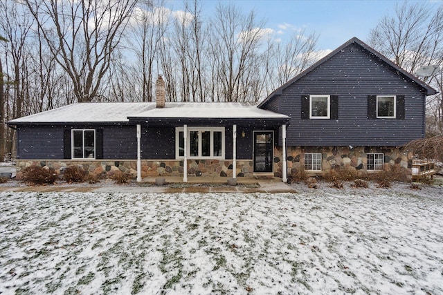 view of snow covered rear of property