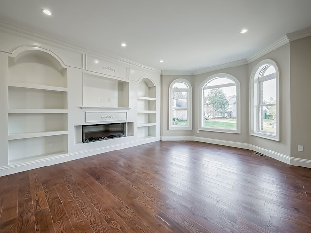 unfurnished living room with dark hardwood / wood-style flooring, crown molding, and built in features