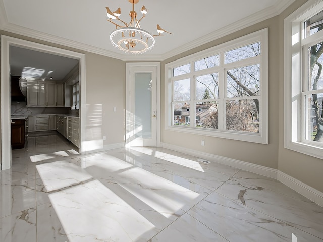 unfurnished dining area with a chandelier, ornamental molding, and a healthy amount of sunlight