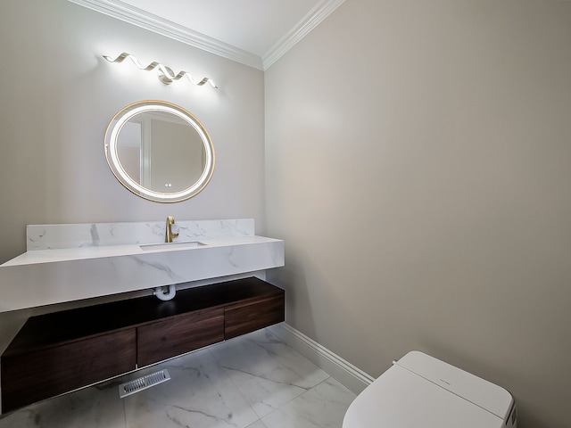 bathroom with vanity, toilet, and crown molding