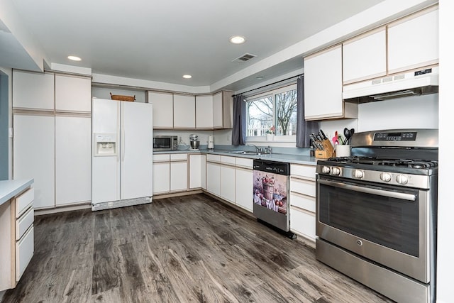 kitchen featuring dark hardwood / wood-style flooring, sink, white cabinets, and appliances with stainless steel finishes