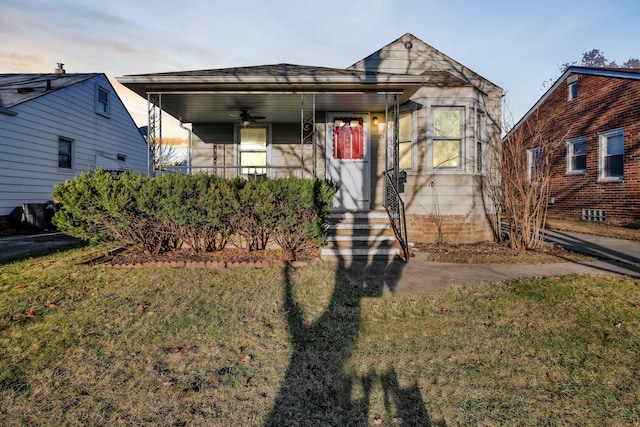 view of front of house with a porch and a yard