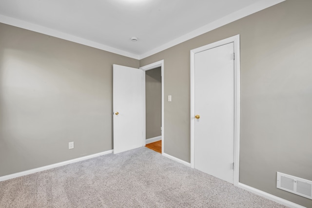 unfurnished bedroom featuring light colored carpet