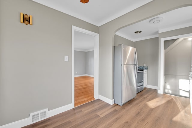 interior space featuring stainless steel fridge and light wood-type flooring