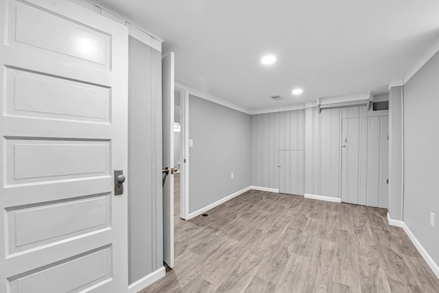 interior space featuring light hardwood / wood-style flooring and crown molding