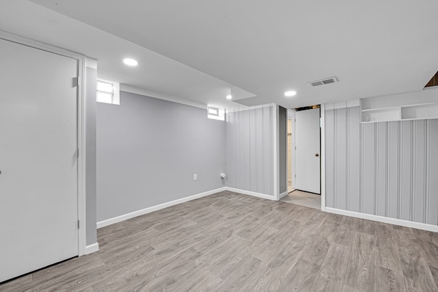 basement with light hardwood / wood-style floors