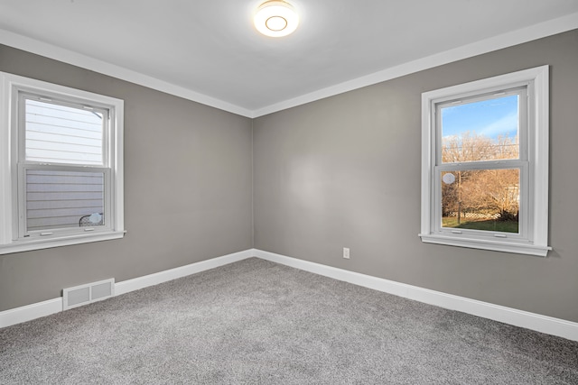 carpeted spare room with ornamental molding