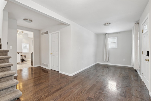 spare room featuring dark wood-type flooring