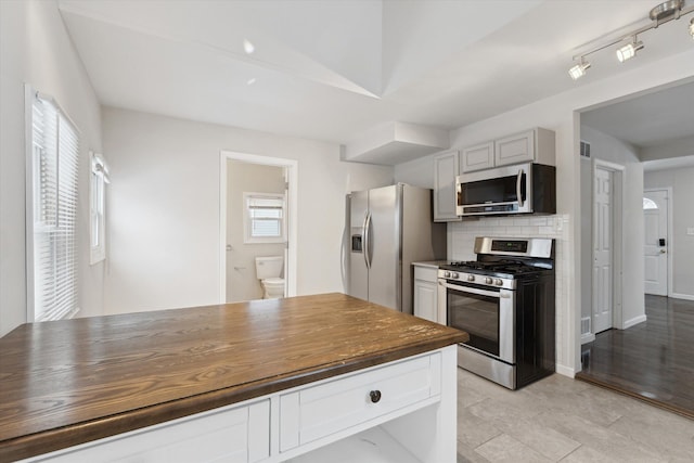 kitchen featuring gray cabinetry, decorative backsplash, plenty of natural light, and stainless steel appliances