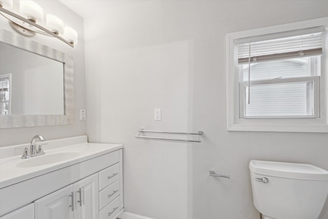 bathroom featuring vanity, toilet, and a wealth of natural light