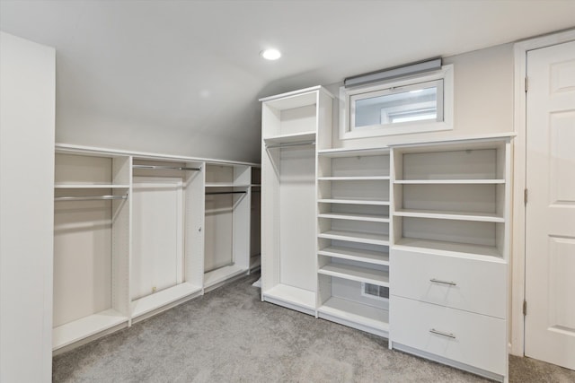 spacious closet featuring light carpet and lofted ceiling