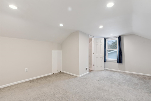 bonus room with light carpet and lofted ceiling