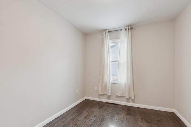 spare room with dark hardwood / wood-style floors