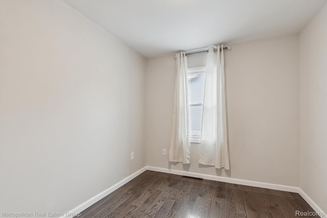 1597 W Saratoga St, Ferndale, MI 48220 - empty room featuring dark wood-type flooring and baseboards