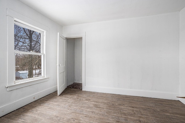 unfurnished room featuring hardwood / wood-style floors and a healthy amount of sunlight