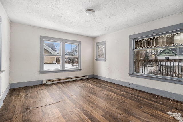 unfurnished room featuring a textured ceiling, dark hardwood / wood-style floors, and baseboard heating