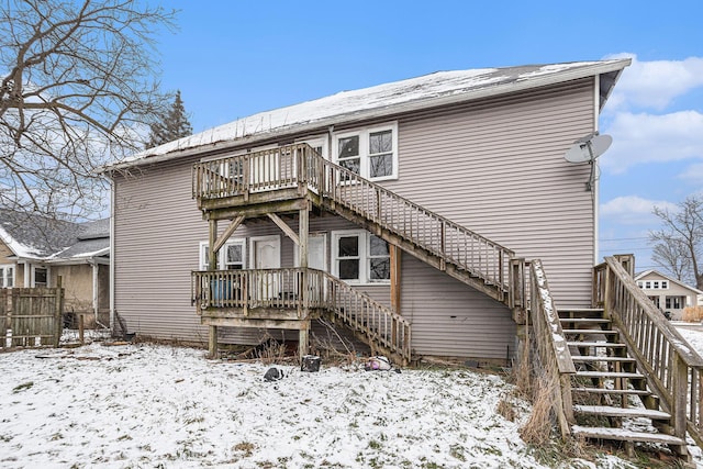 view of snow covered rear of property