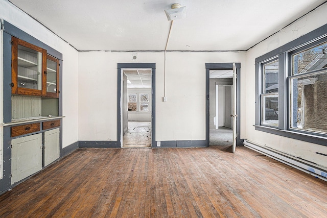 interior space featuring dark hardwood / wood-style flooring and a baseboard heating unit