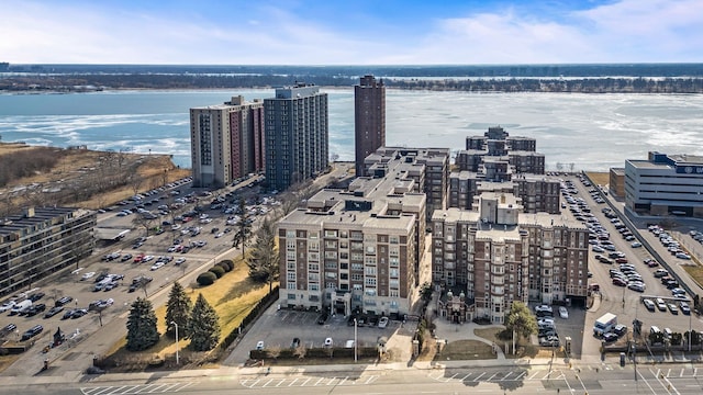 birds eye view of property with a water view and a city view