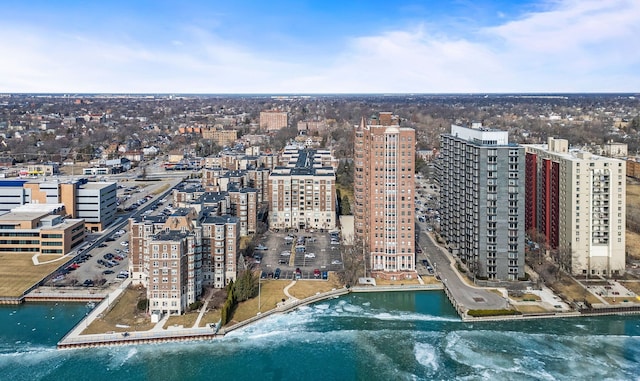 drone / aerial view featuring a city view and a water view