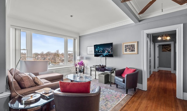 living area with ornamental molding, wood finished floors, beam ceiling, and a notable chandelier